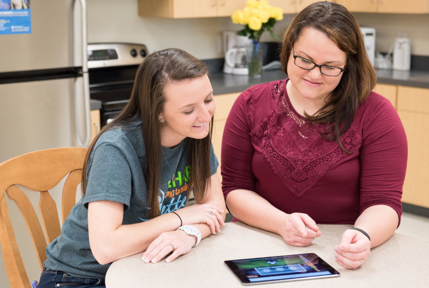 Two students sitting at a table studying for the exam. 